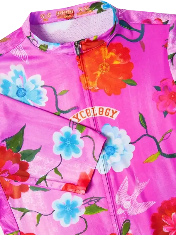 Vibrant pink women's cycling jersey with floral and bird print, full zip, performance fabric