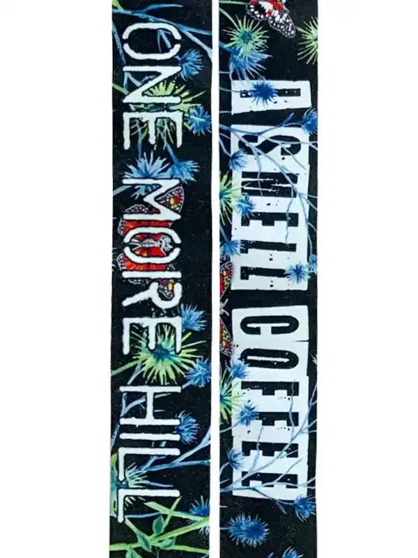 Cycling socks with 'One More Hill I Smell Coffee' text and floral design on black background