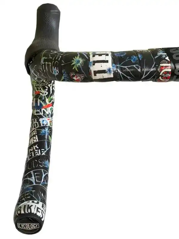 Cycology branded cycling handlebar tape with floral and text print, black grip, stylish road bike accessory