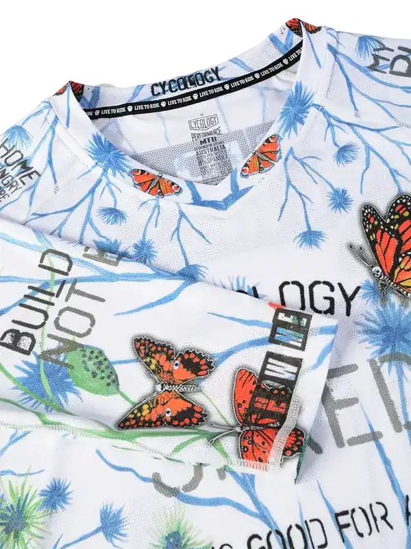 White cycling jersey with butterfly print, blue branches, and bold text for men's or women's bike wear