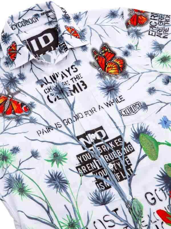 White cycling shirt with butterfly and floral print, bold text graphics, and performance fabric design