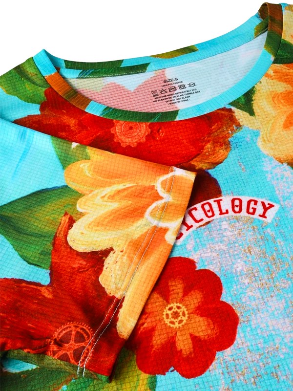 Close-up of a colorful floral-patterned shirt with visible brand name.
