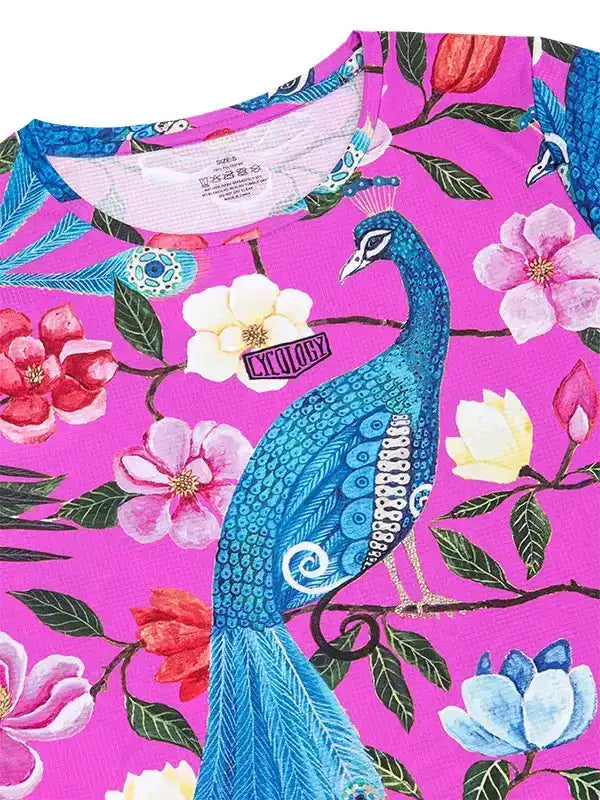 Vibrant pink cycling jersey with blue peacock and floral print, featuring unique design for women's bike wear.