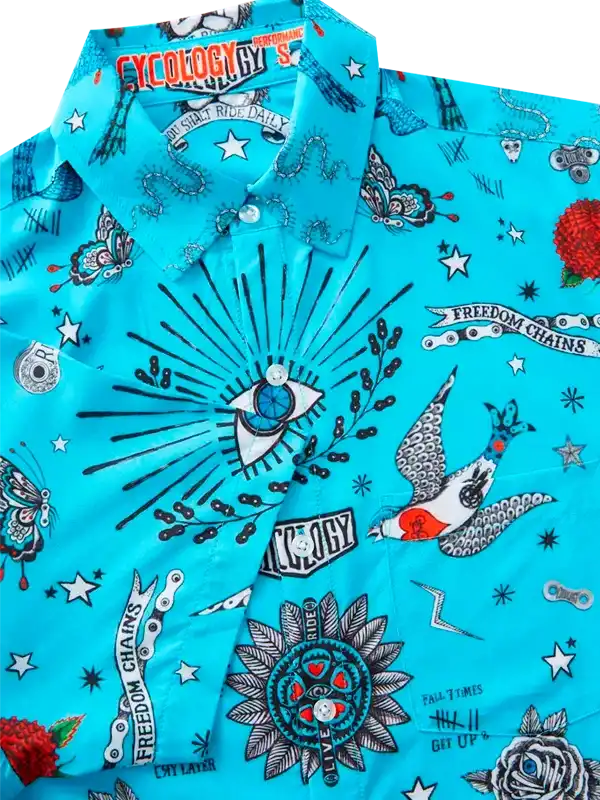 Vibrant turquoise cycling shirt with bold tattoo-style graphics, stars, and 'Freedom Chains' print for men and women.