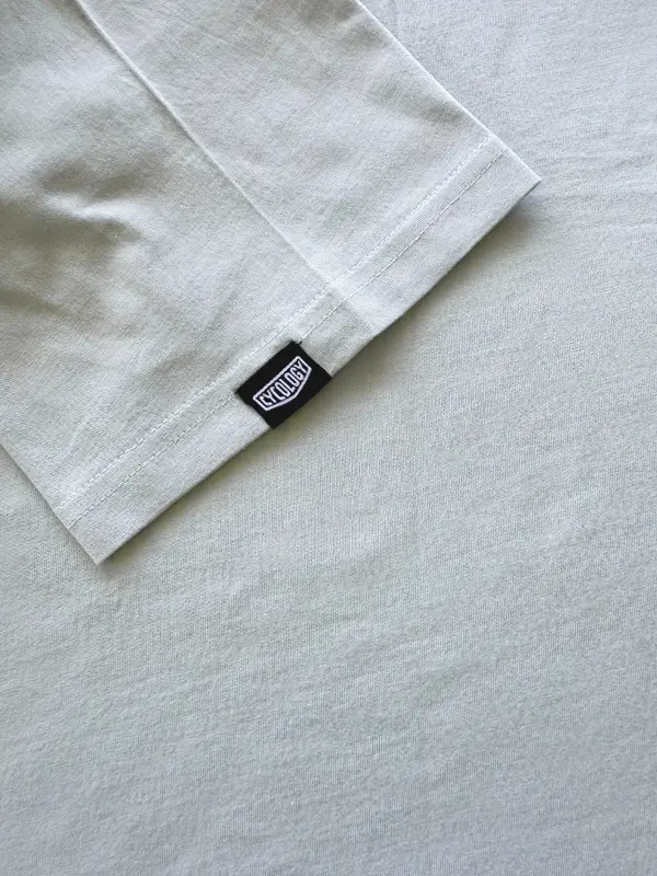 Light gray t-shirt with a brand label on sleeve 