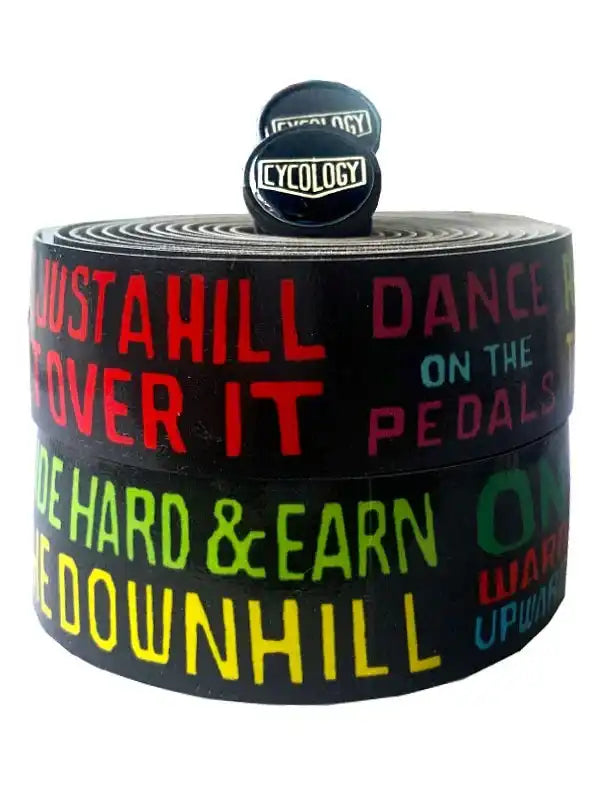 Cycling handlebar tape with bold motivational phrases like 'Just a Hill Over It' and 'Dance on the Pedals'