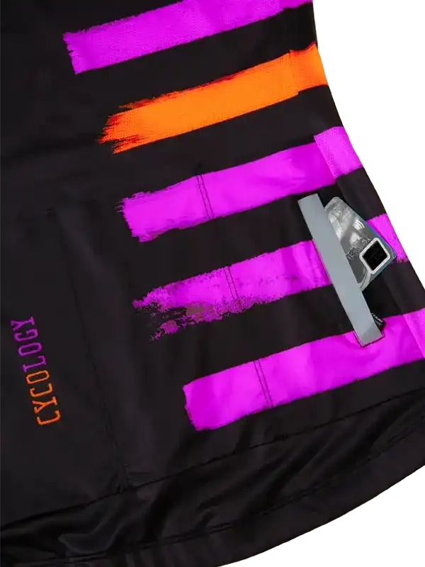 Black cycling shorts with bold neon pink and orange brushstroke stripes, featuring rear pocket and reflective details