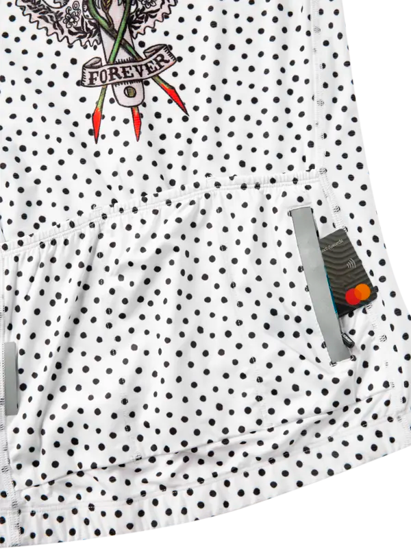 White cycling jersey with black polka dots and a tattoo-style graphic on a white background 