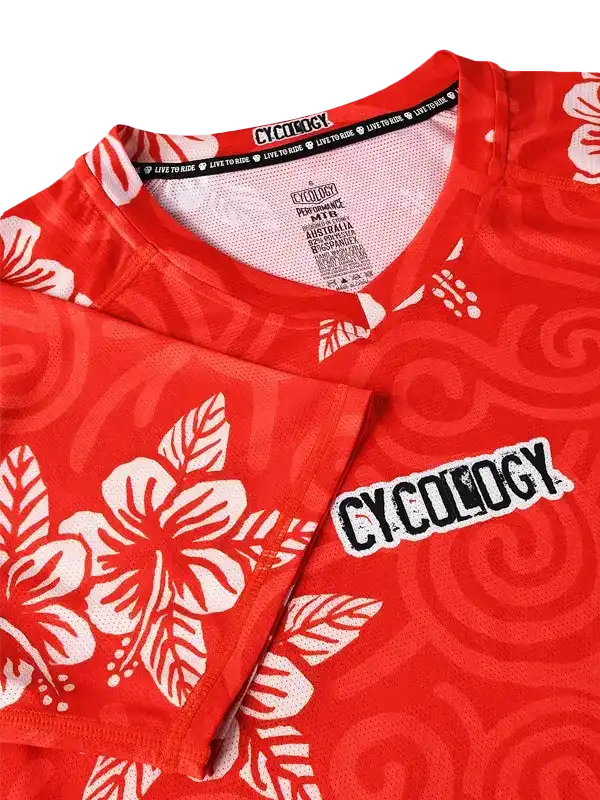Red cycling jersey with white hibiscus print and Cycology logo, performance MTB design