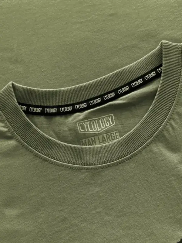Close-up of a green t-shirt with 'Cycology' branding on the collar and label.
