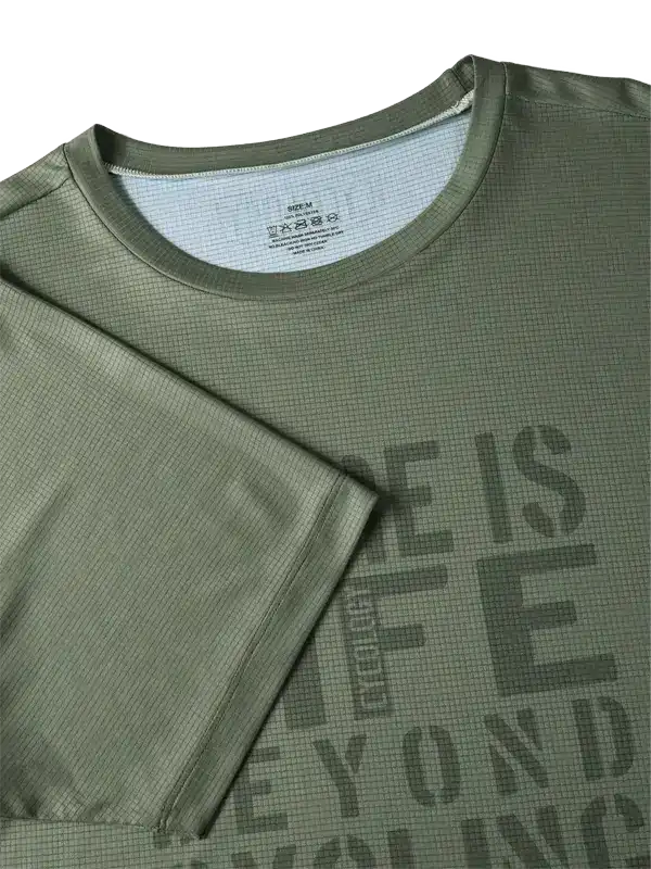 Olive green men's cycling jersey with textured fabric and bold graphic print, ideal for performance rides.