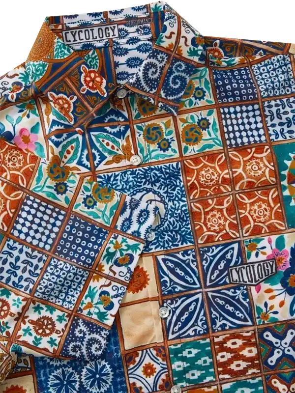 Colorful patchwork cycling shirt with floral and geometric patterns, button-up design