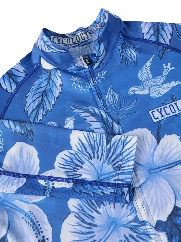 Blue cycling jersey with floral and bird print, featuring high-quality fabric and zipper detail