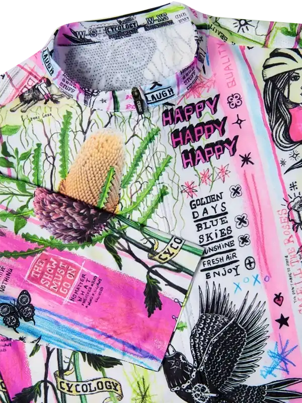 Vibrant cycling jersey with floral, bird, and 'Happy' print design, featuring bold pink and green colors
