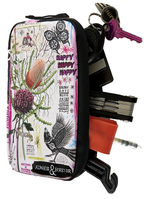 A zippered fabric pouch with a detailed botanical and bird tapestry-style print, shown holding keys, a multi-tool, and other accessories against a white background.