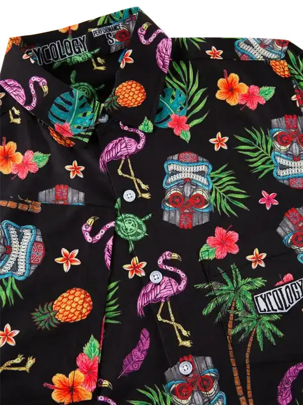 Black tropical cycling shirt with flamingos, pineapples, hibiscus, and tiki masks on performance fabric