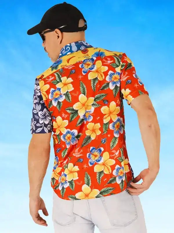 Man wearing vibrant floral cycling shirt with orange background and tropical print, ideal for casual rides.