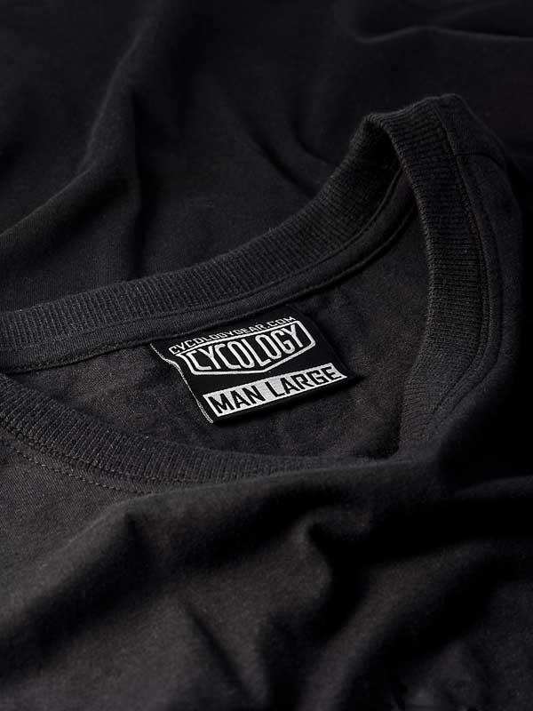 Black cycling t-shirt with Cycology brand label and size tag, ideal for men's active wear.
