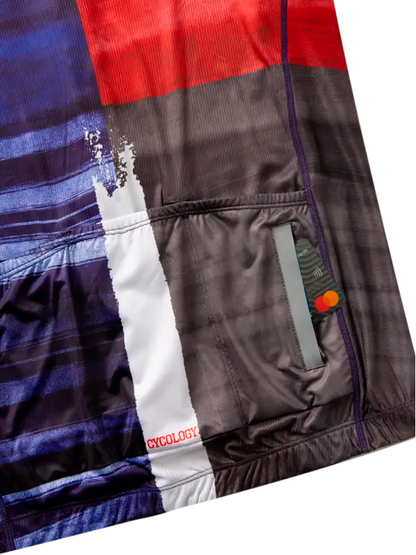Cycling jersey with red, blue, and black block design back pockets