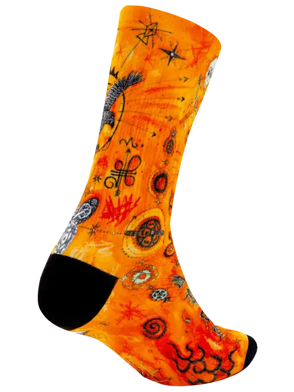 Vibrant orange cycling sock with cosmic and abstract designs, black toe and heel accents