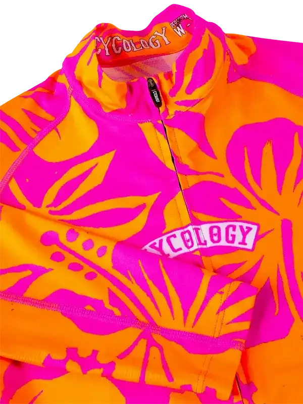 Vibrant pink and orange tropical print women's cycling jersey with half-zip and brand logo