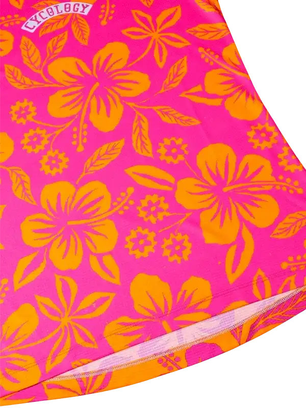 Vibrant pink cycling jersey with bold orange hibiscus floral print, featuring seamless stitching and performance fabric.