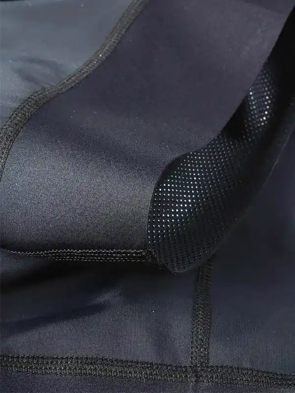 Black cycling shorts with perforated padding and flatlock seams for comfort and breathability