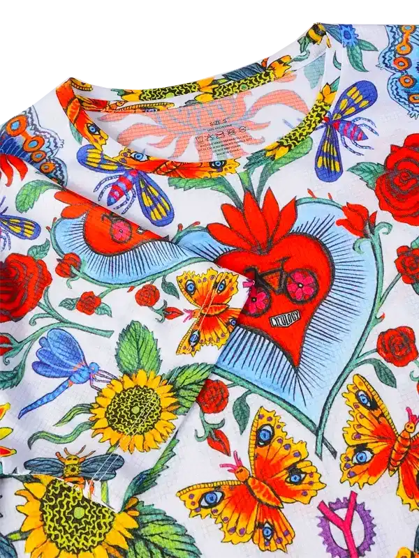 Vibrant floral and butterfly print cycling jersey with heart design, ideal for women's bike wear