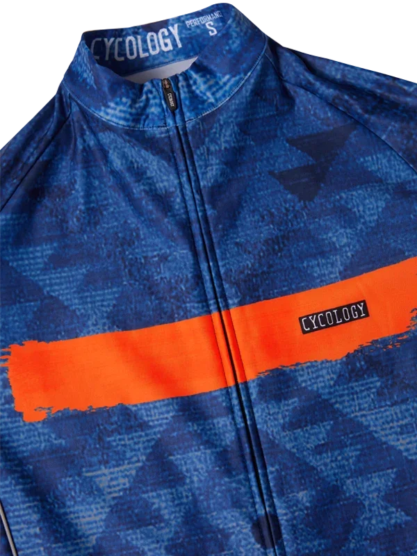 Blue cycling jersey with orange stripe, geometric pattern, and full zip front for men's and women's rides