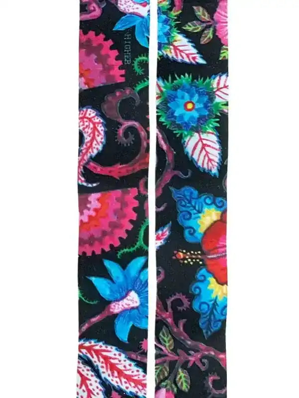 Vibrant floral cycling socks with bold pink, blue, and green patterns on black background for men and women riders