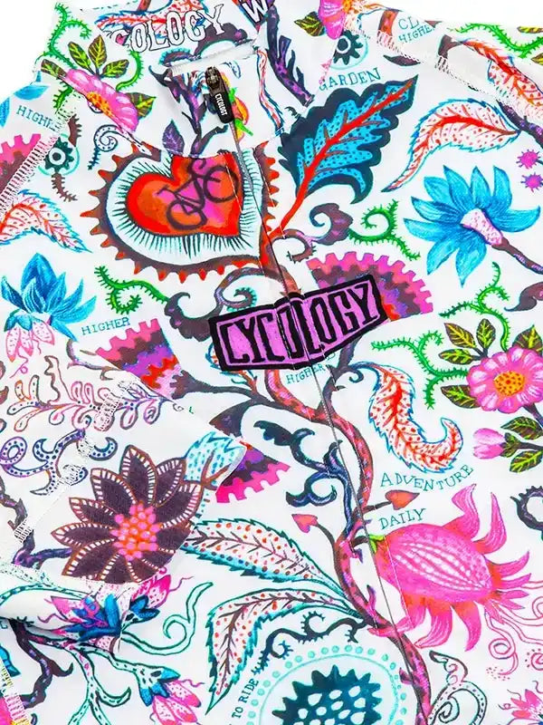 Vibrant floral cycling jersey with bold 'Cycology' patch and heart-bike graphic, perfect for adventure rides.