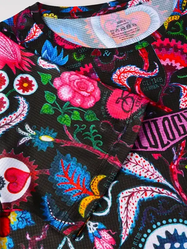 Vibrant floral and graphic print cycling jersey with bold colors and motivational phrases