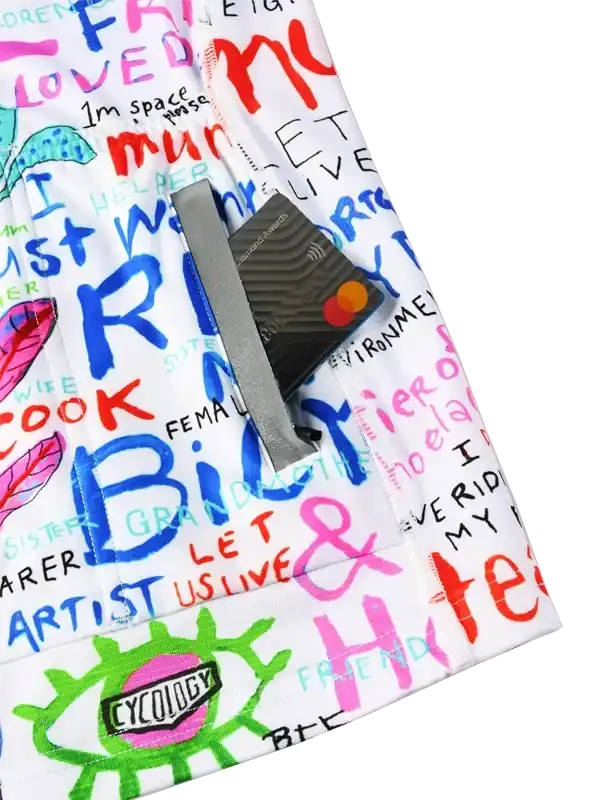Colorful graffiti-style cycling shorts with bold text and Cycology logo, featuring secure card pocket