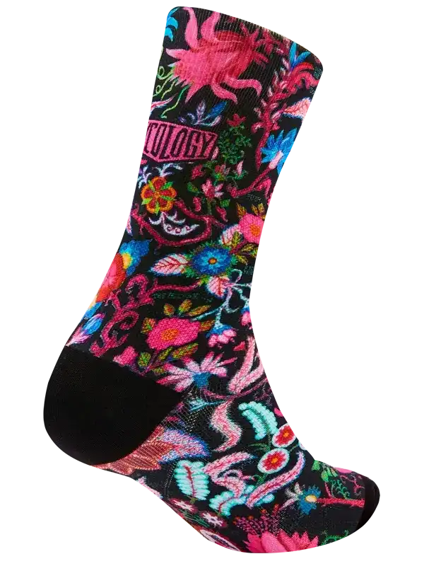 Vibrant floral cycling sock with bold pink, blue, and green patterns on black background, ideal for road or mountain biking.