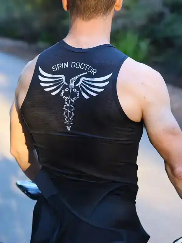 Men's black cycling tank top with 'SPIN DOCTOR' winged spine graphic, worn outdoors on bike ride