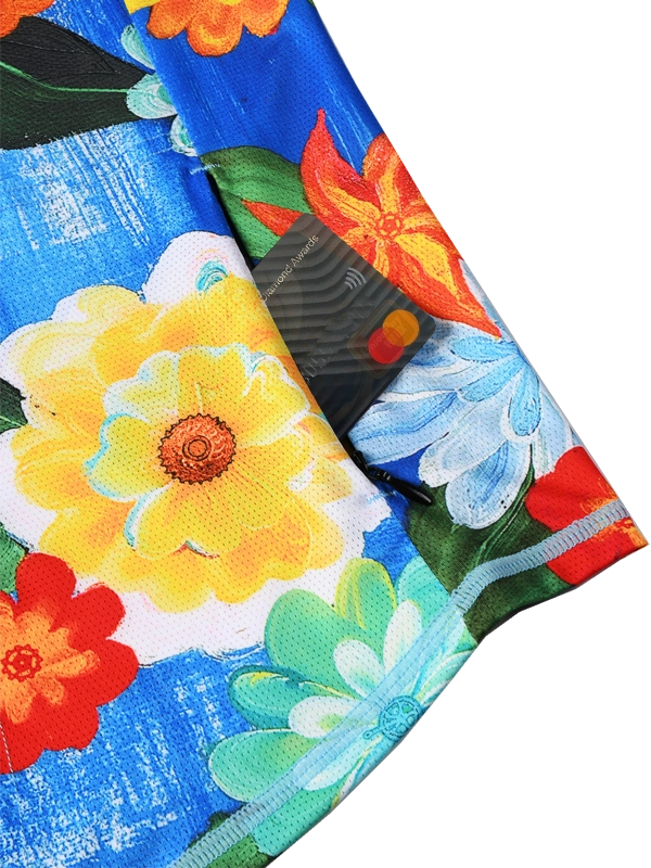 Close-up of a colorful floral fabric with vibrant flowers on a blue background