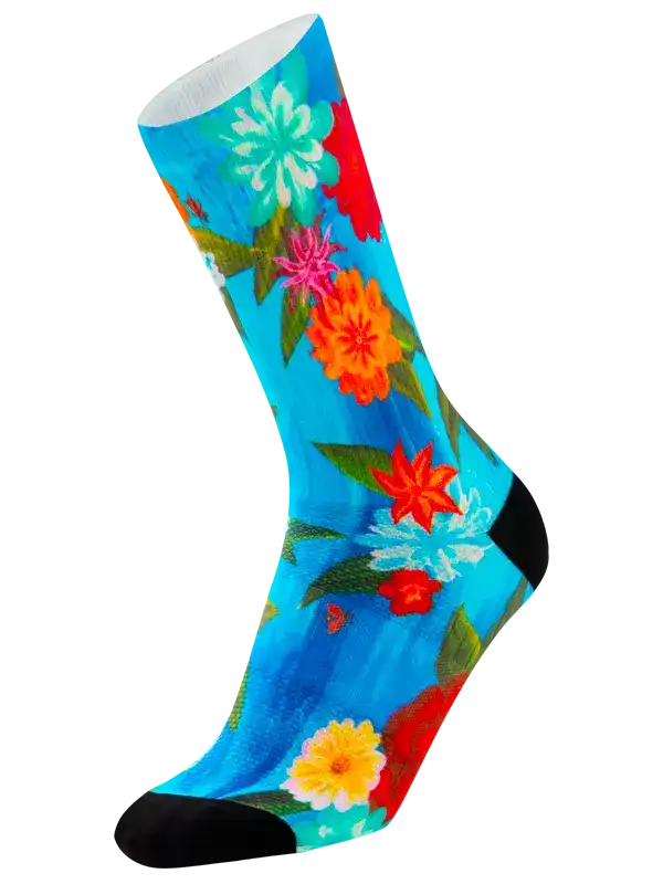 Vibrant floral cycling socks with blue background, colorful flowers, and black toe/heel accents for men and women.