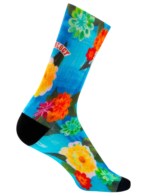 Vibrant floral cycling socks with blue background, colorful blooms, and black toe/heel accents for bike rides.