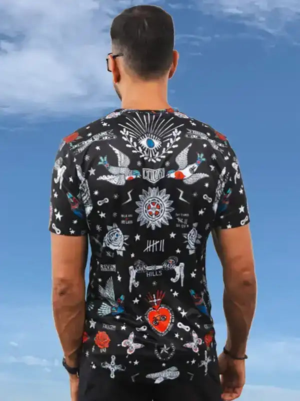 Men's cycling jersey with bold tattoo-style graphics, stars, and symbols on black fabric, perfect for road rides.