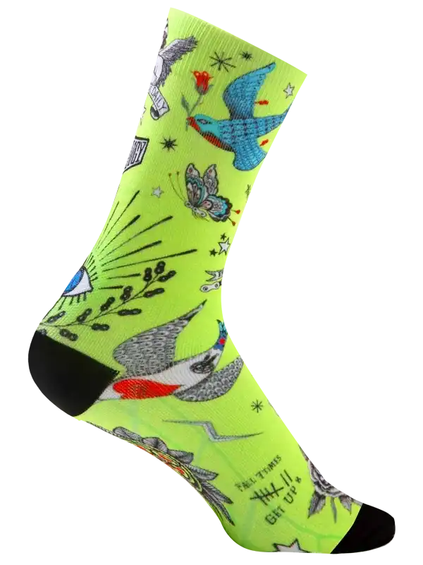 Vibrant neon green cycling sock with tattoo-style birds, butterflies, and stars for men and women