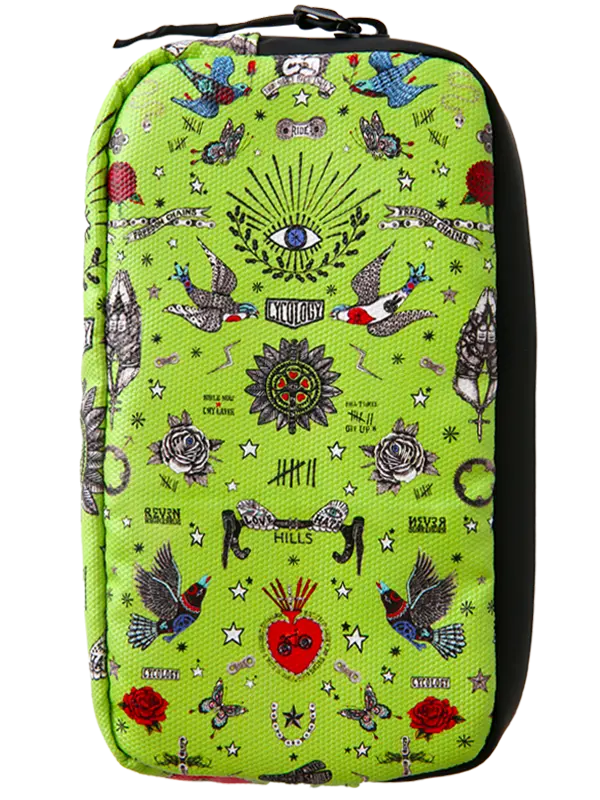 A bright lime green zippered cycling wallet featuring a detailed tattoo-style print with birds, roses, stars, and a central eye motif, shown against a plain white background.
