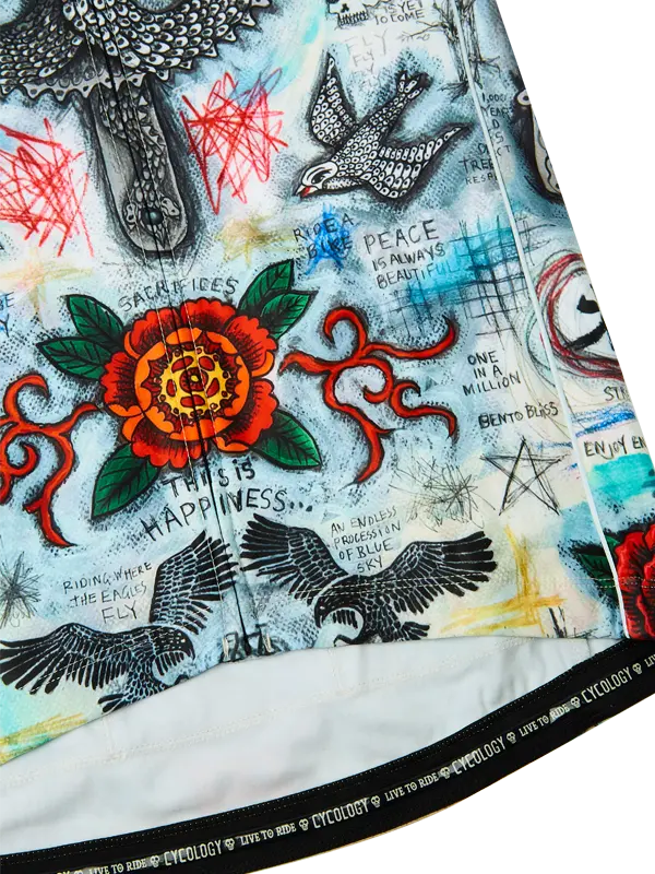 Close-up of a colorful fabric with tattoos, flowers, and text.