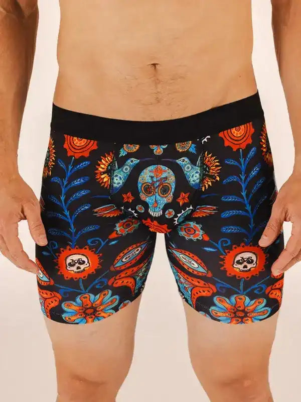 Men's cycling shorts with vibrant sugar skull and floral print, bold orange and blue design