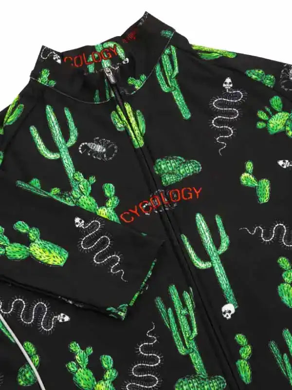 Black cycling jersey with green cactus, snake, and skull print, featuring full zipper and 'CYCOLOGY' branding.
