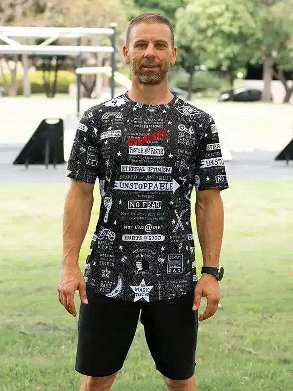 Man wearing black graphic cycling jersey with motivational slogans, ideal for men's cycling apparel