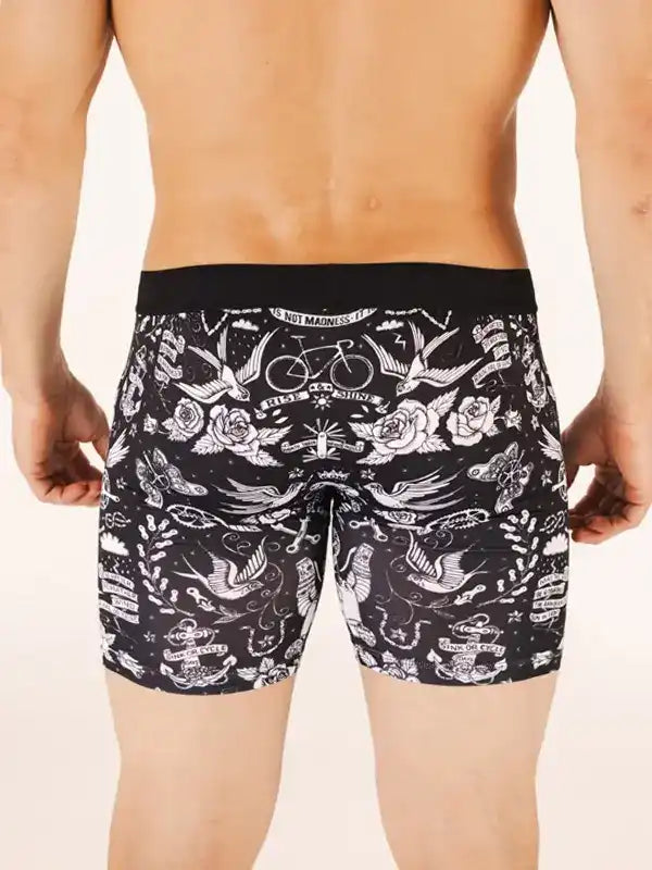 Men's cycling shorts with black and white tattoo-style print featuring bikes, roses, and birds