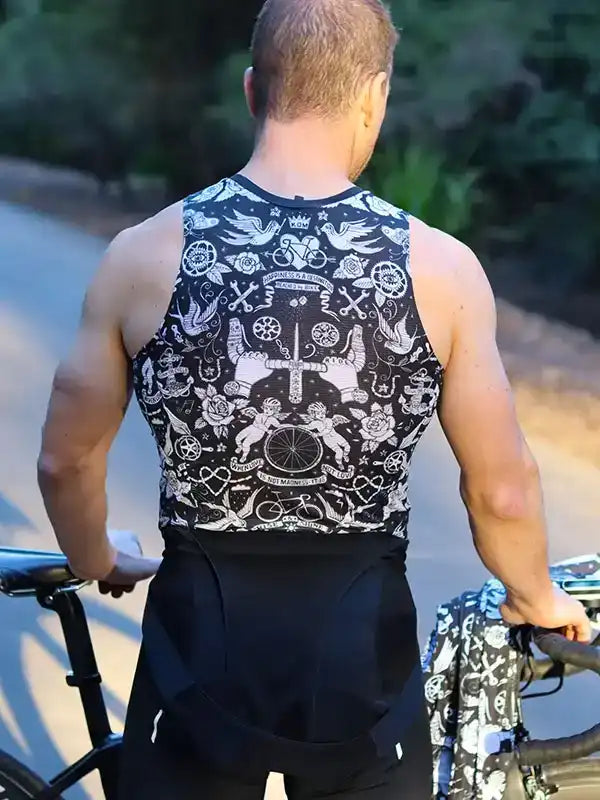 Men's cycling jersey with bold black and white tattoo-style graphics, worn on a bike ride outdoors