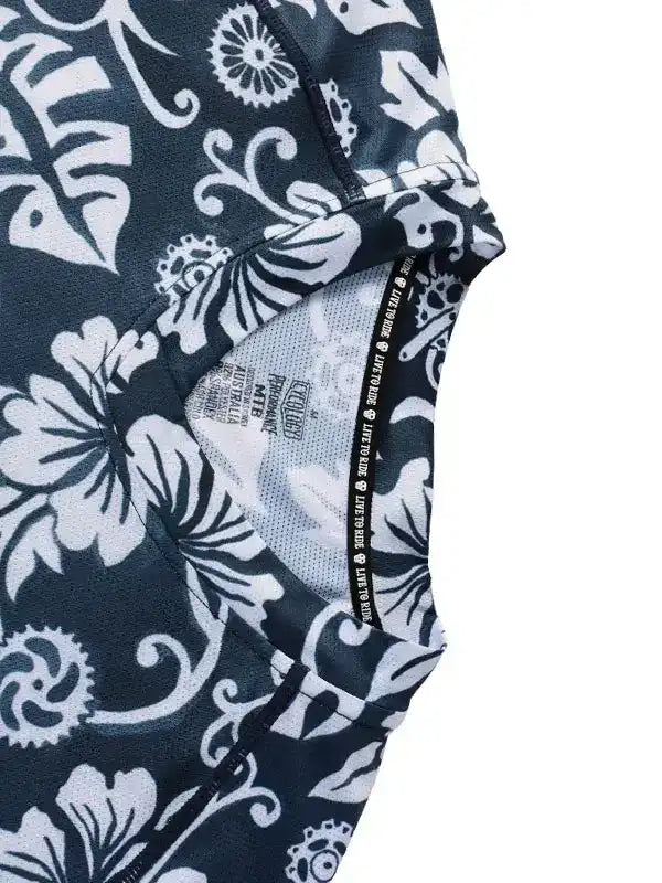Black and white floral cycling jersey with gear pattern, breathable mesh lining, and performance tag detail