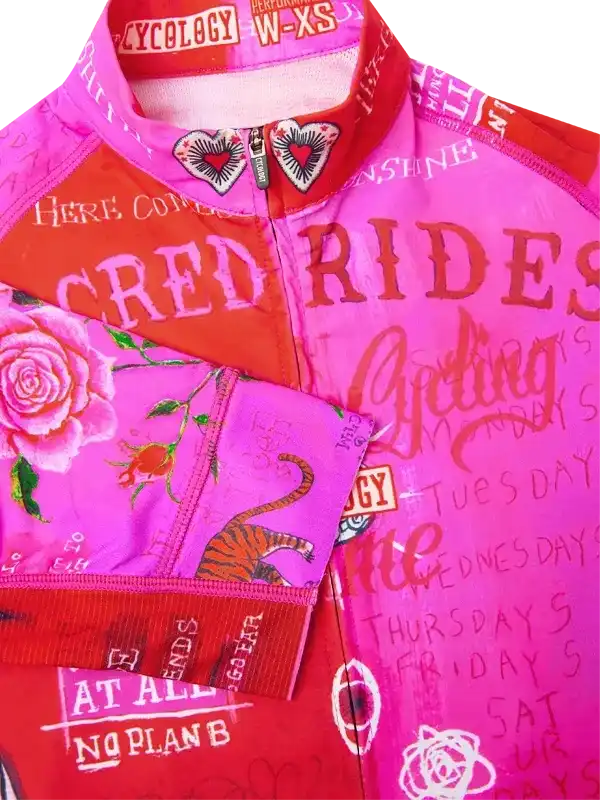 Vibrant pink women's cycling jersey with rose, tiger, and 'Red Rides' graphic design, performance fabric