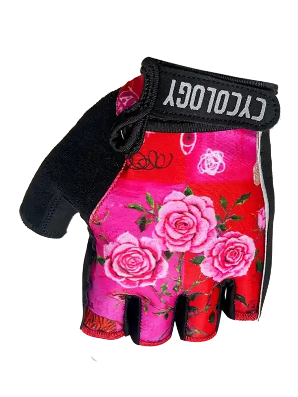 Women's cycling glove with pink rose floral print, black palm, and wrist strap for grip and comfort